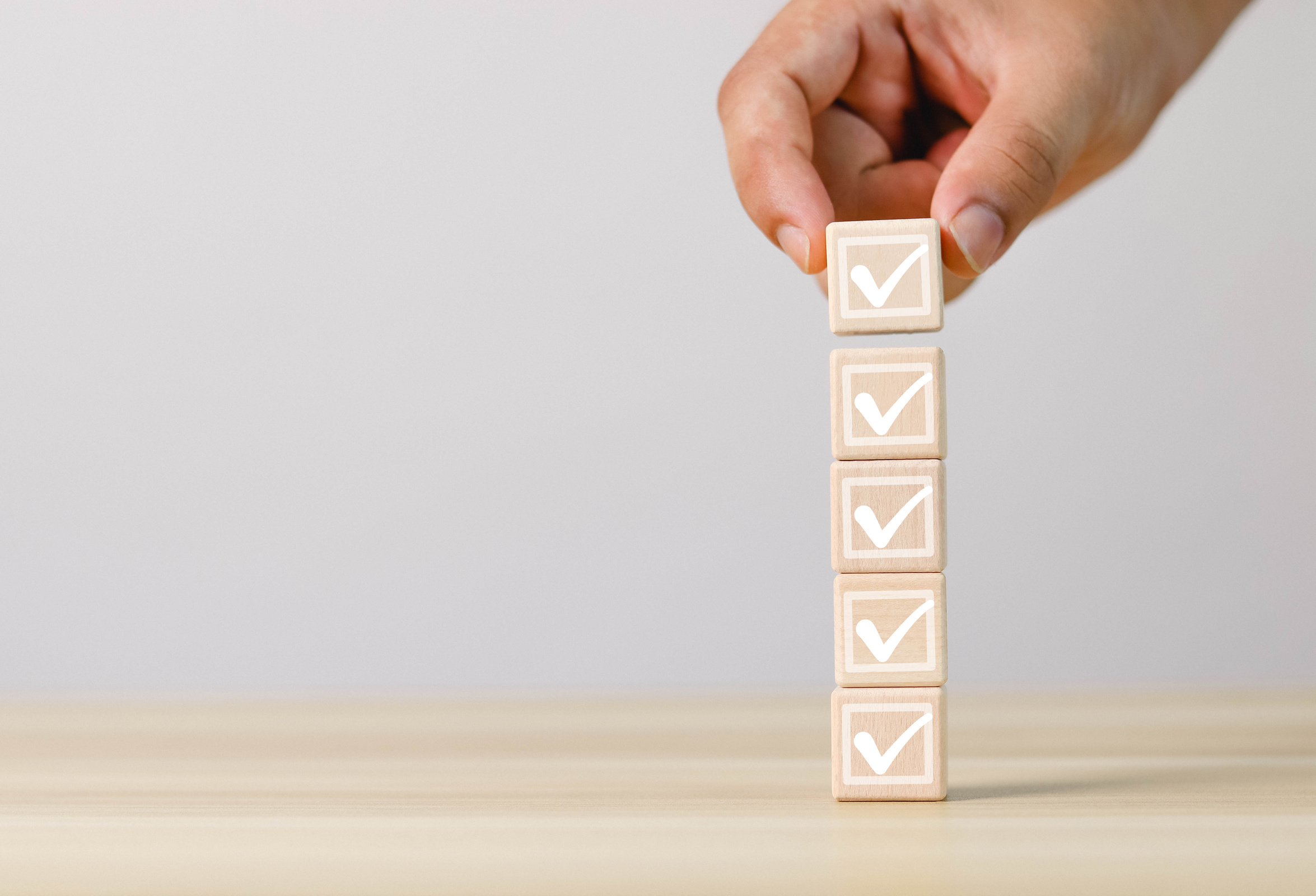 Wooden block with checkmark checklist lined up